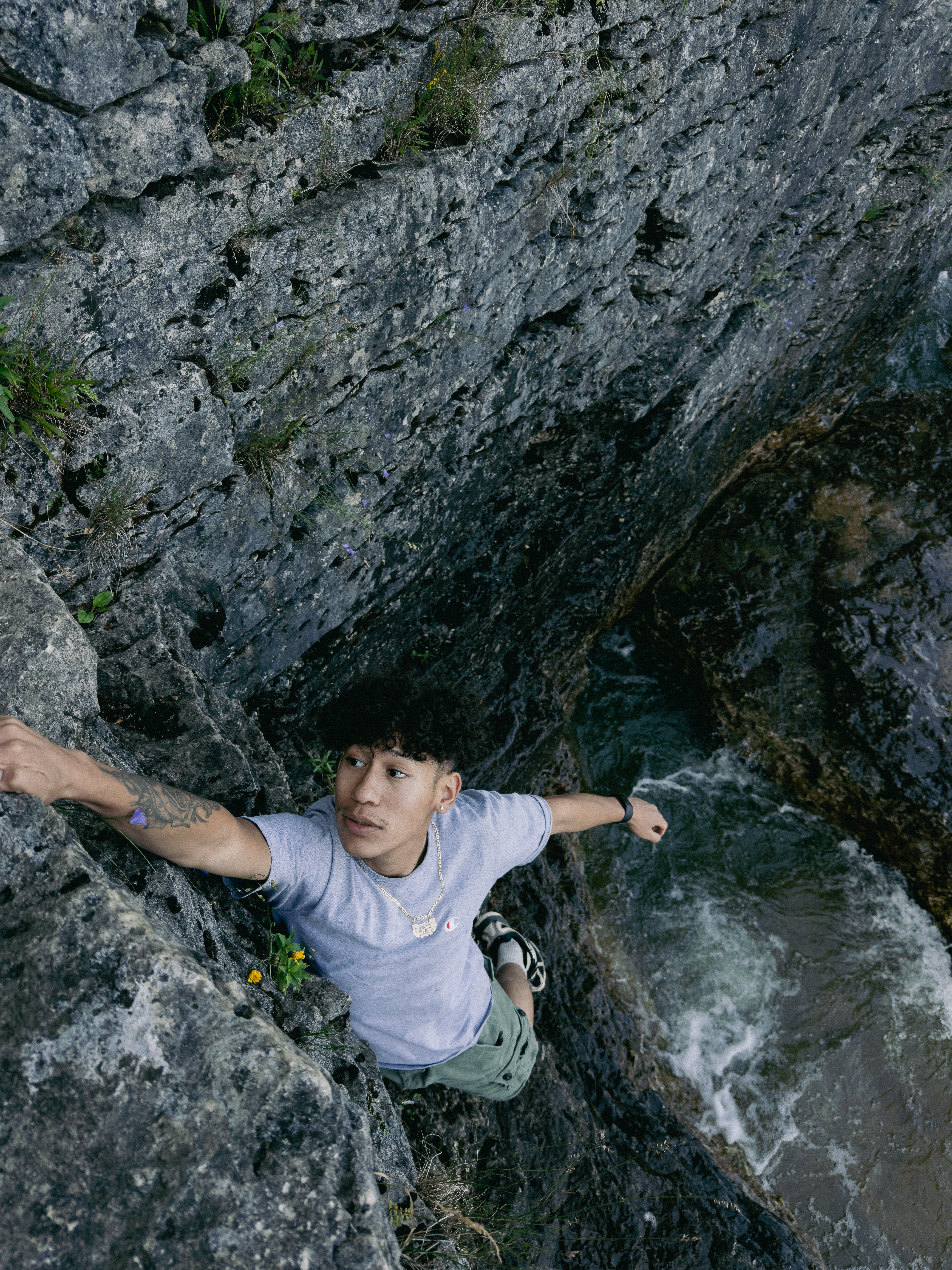 Climber on rock face above water
